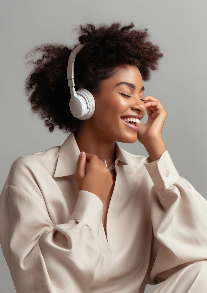 African american woman hand touching wireless earphone in ears headphones headset person. AI generated Image by rawpixel.