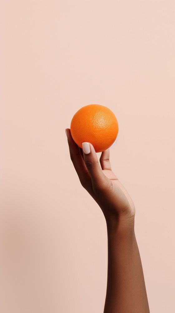 Hand holding an orange grapefruit food clementine. AI generated Image by rawpixel.