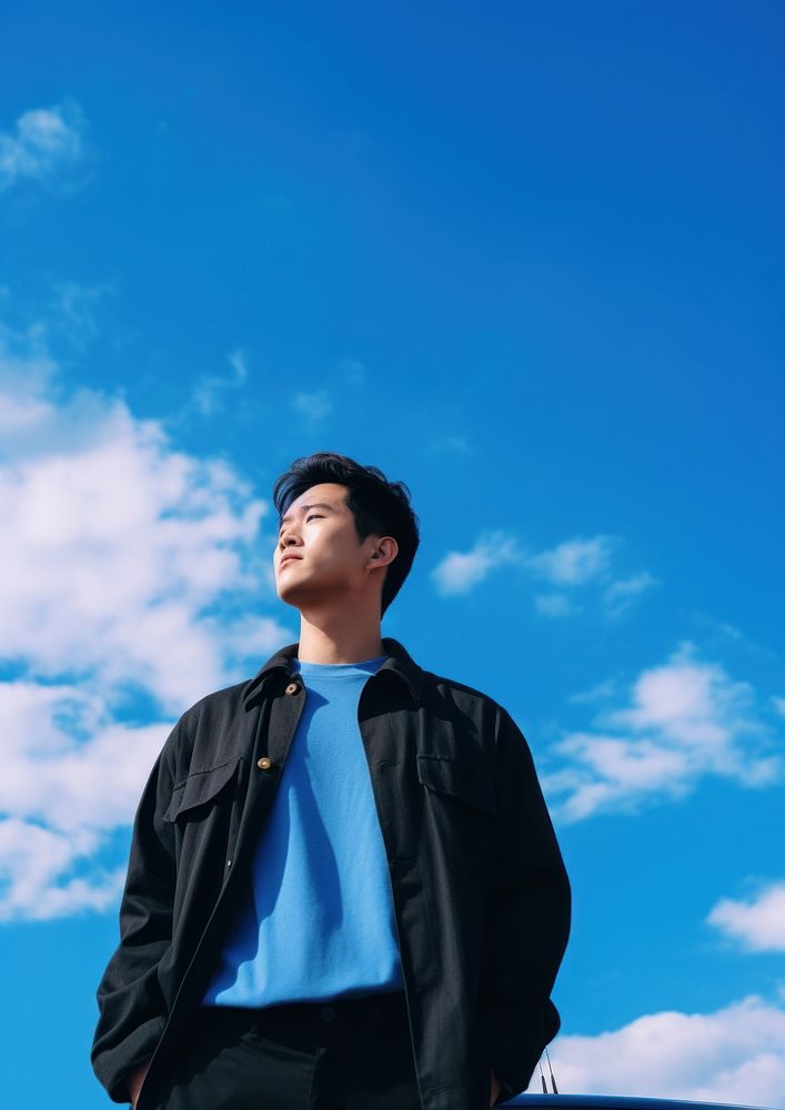 Thai young man standing blue sky. AI generated Image by rawpixel.