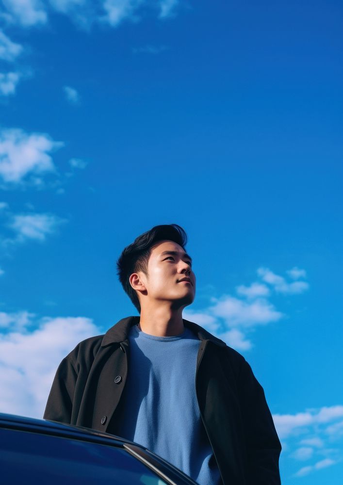 Thai young man standing blue sky. AI generated Image by rawpixel.