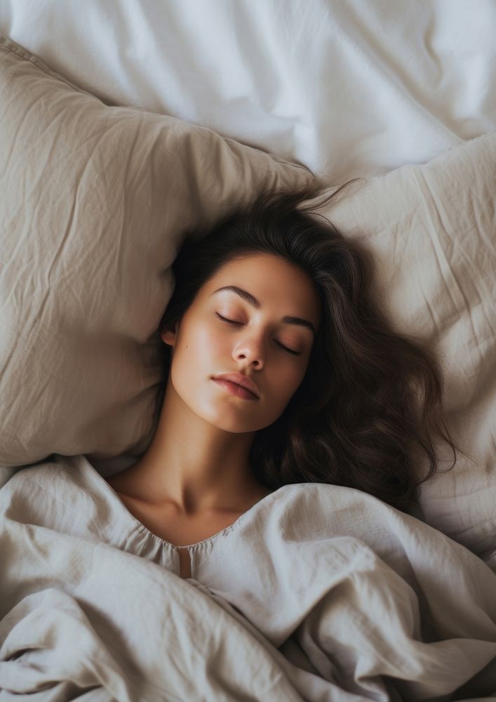 A woman laying comfortably in the bed blanket sleeping pillow. AI generated Image by rawpixel.