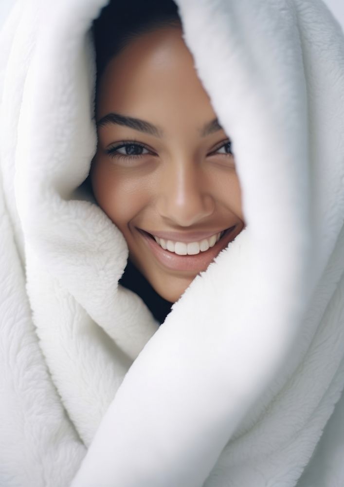 A smiling woman wrapped up in a white blanket smile adult skin. AI generated Image by rawpixel.