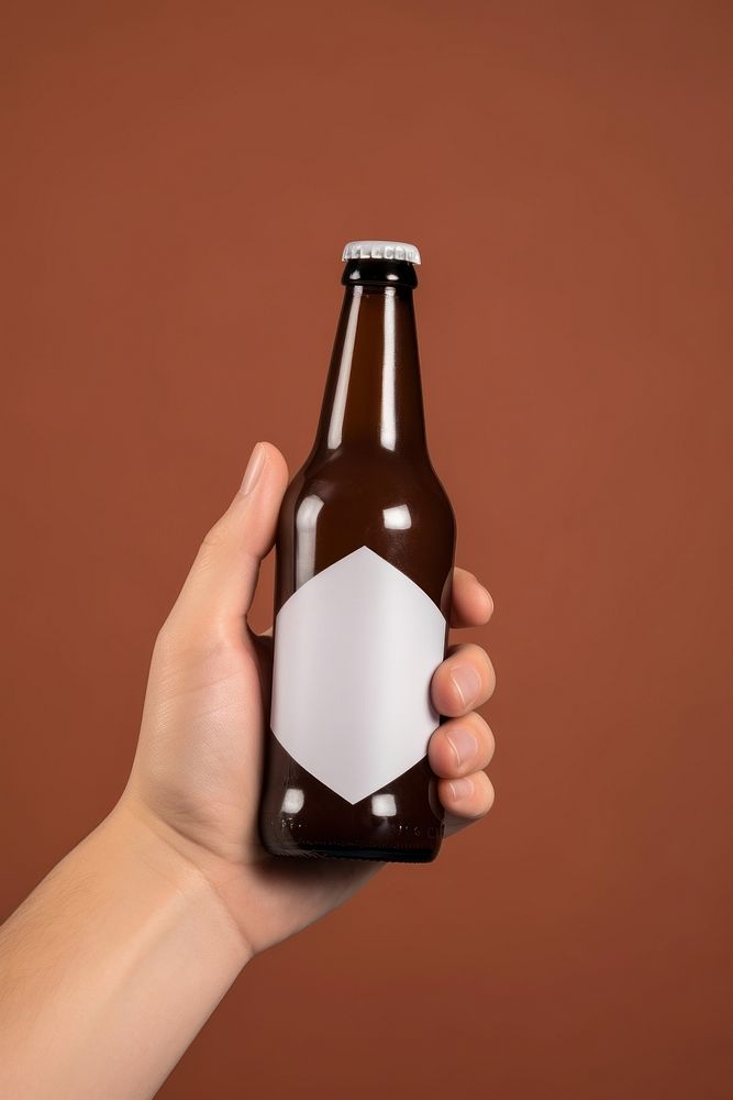 Beer bottle with white lable holding drink hand. AI generated Image by rawpixel.