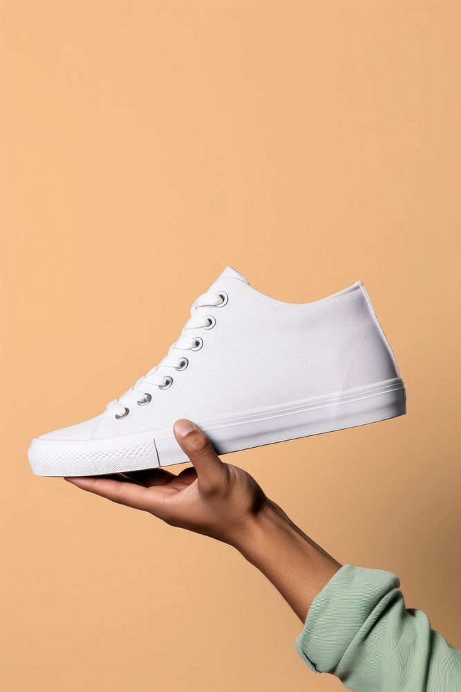 Canvas shoes footwear white hand. AI generated Image by rawpixel.