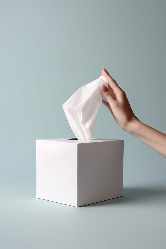 Tissue box with hand pulling napkin out holding tissue white. AI generated Image by rawpixel.