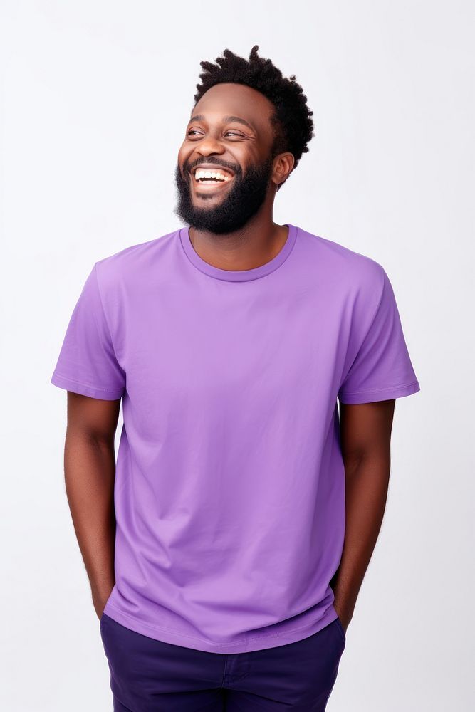 Young african american man with beard wearing casual purple t-shirt looking away to side with smile on face laughing sleeve…