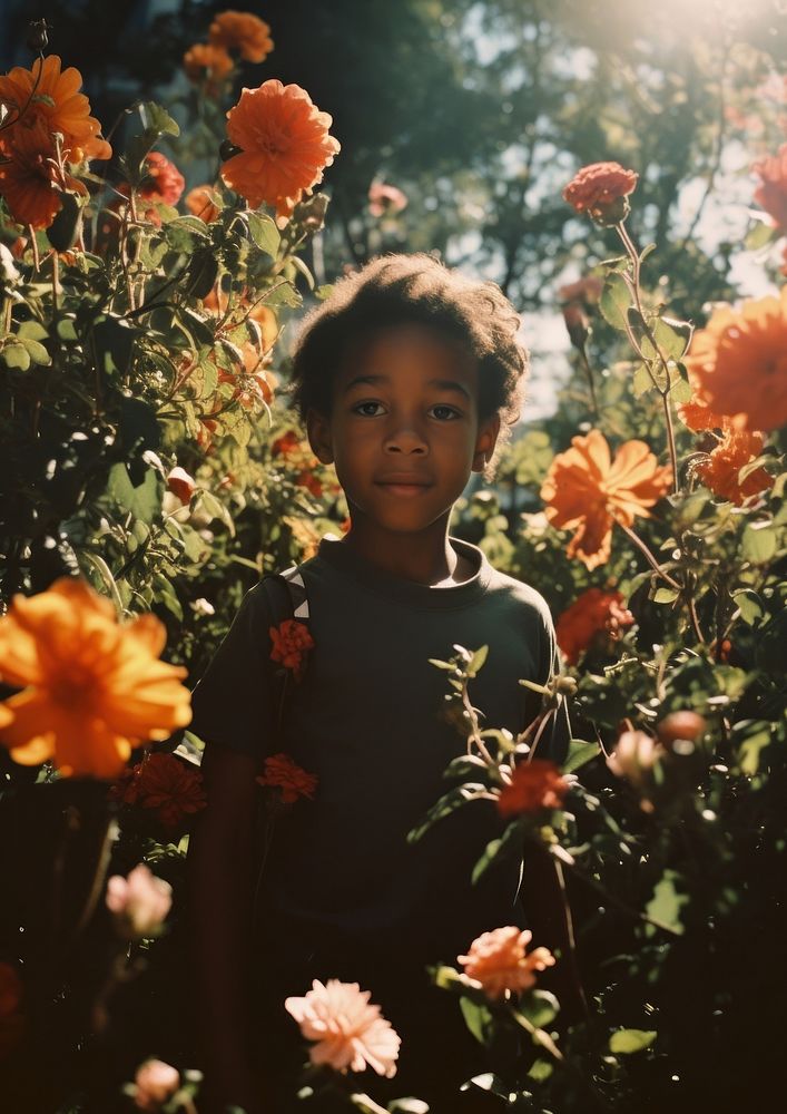 A little black kid in the flower garden photography portrait outdoors. AI generated Image by rawpixel.