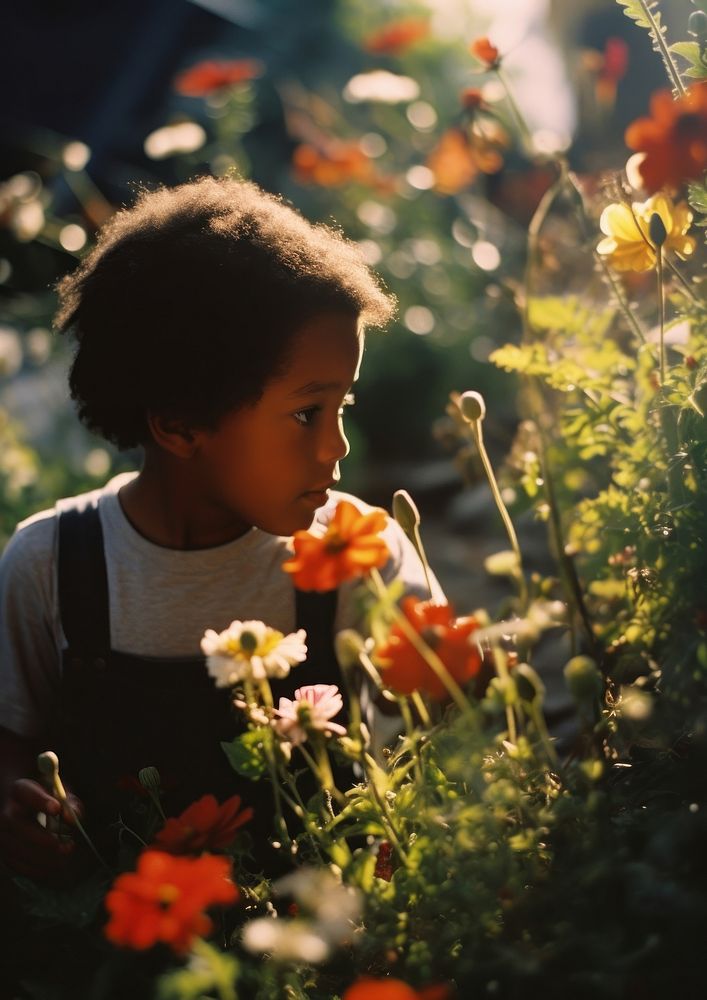 A little black kid in the flower garden photography gardening portrait. AI generated Image by rawpixel.