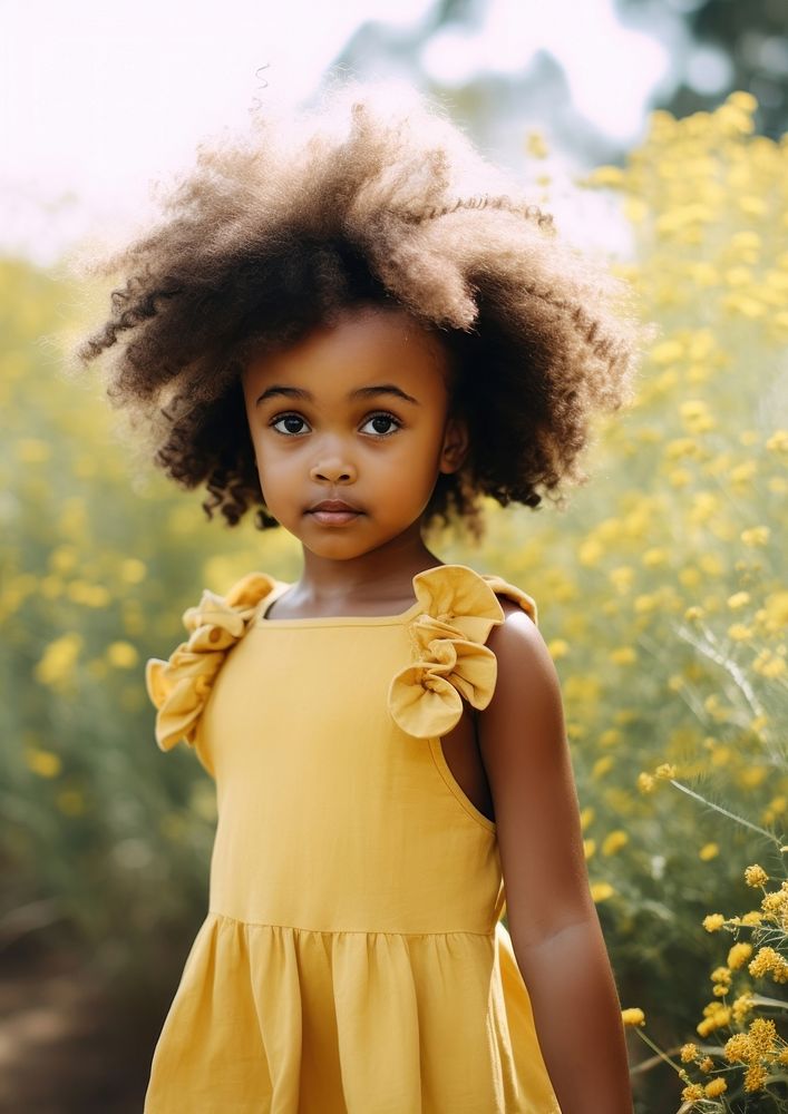A black girl wearing yellow dress and a pink bow hair clip in the yellow flowers garden portrait photography child. AI…