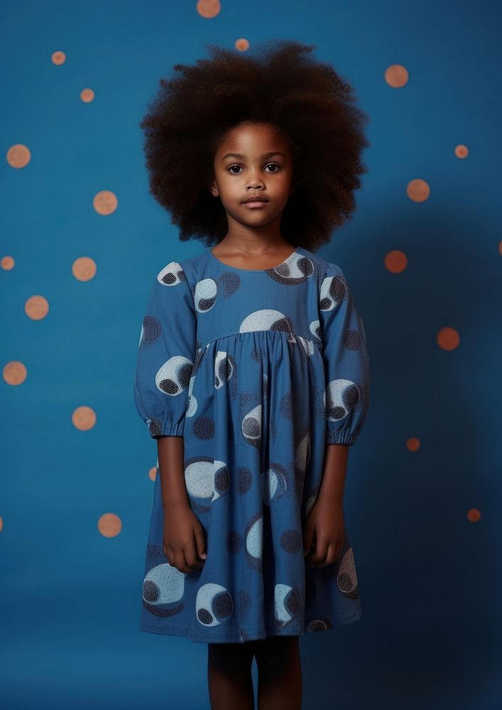 A little black girl wearing cute blue dress with moon pattern photography portrait sleeve. AI generated Image by rawpixel.