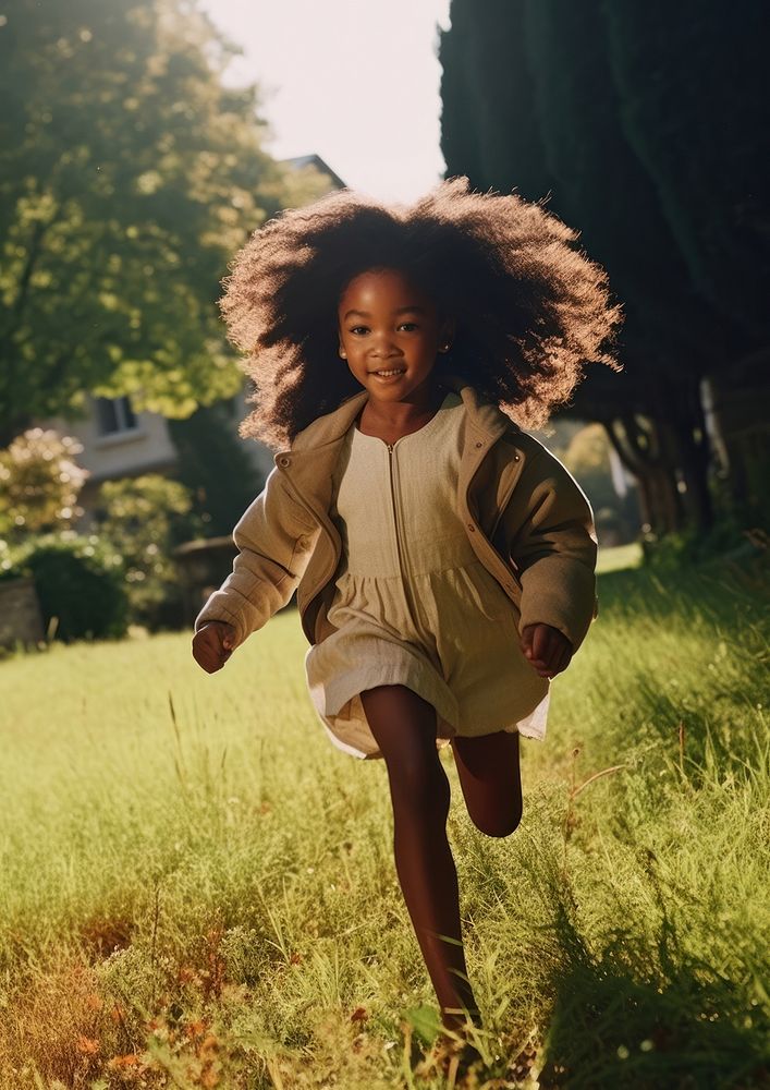 A little black girl running in the green yard day kid happiness. AI generated Image by rawpixel.