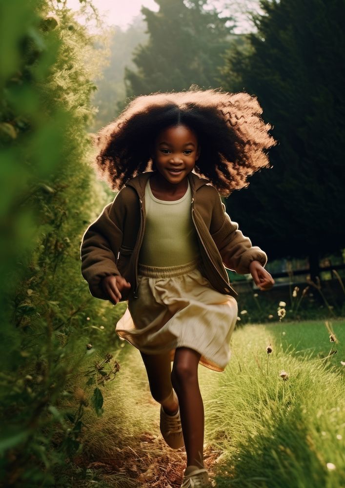 A little black girl running in the green yard photography portrait plant. AI generated Image by rawpixel.
