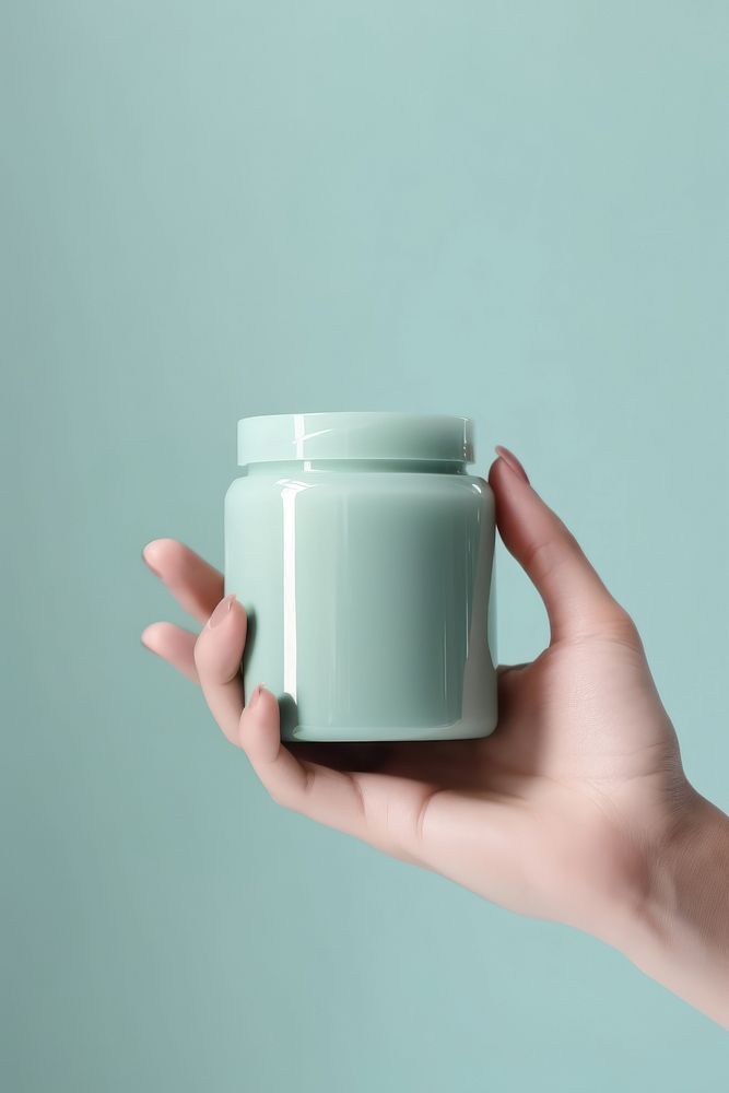 Makeup jar holding hand cup. AI generated Image by rawpixel.