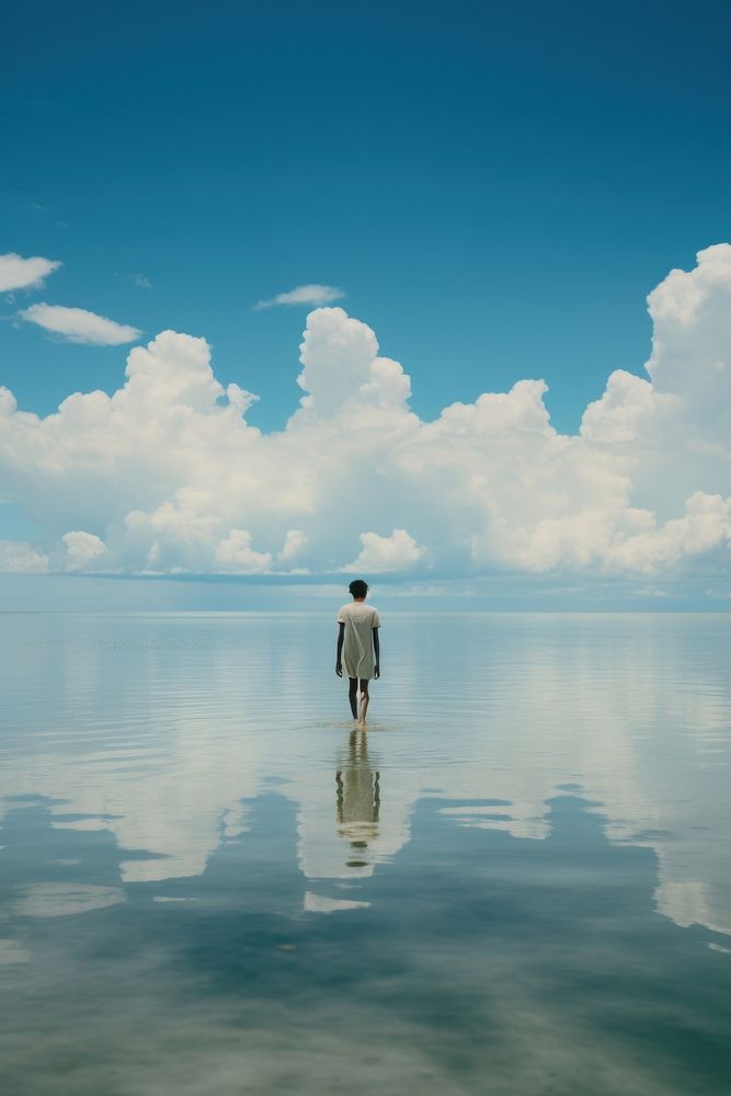 A person walking in the lake sea reflection landscape. AI generated Image by rawpixel.