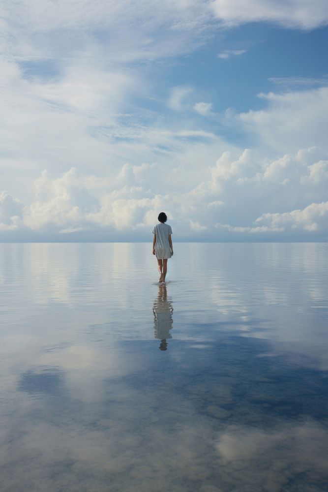 A person walking in the lake sea reflection landscape. AI generated Image by rawpixel.