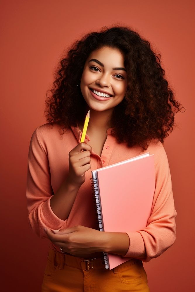 Student holding a book and pencil adult smile publication. AI generated Image by rawpixel.