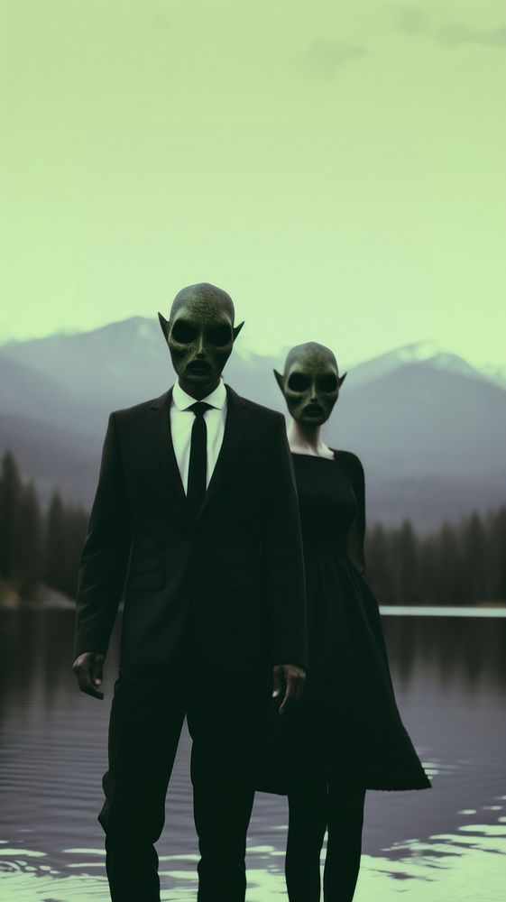 A couple wearing alien mask dressing beautiful standing infront of the river photography sunglasses silhouette. AI generated…
