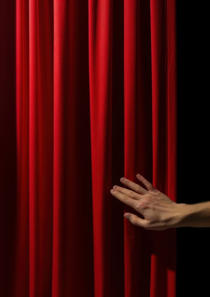 Hand opening a red curtain on stage performance darkness pattern. AI generated Image by rawpixel.
