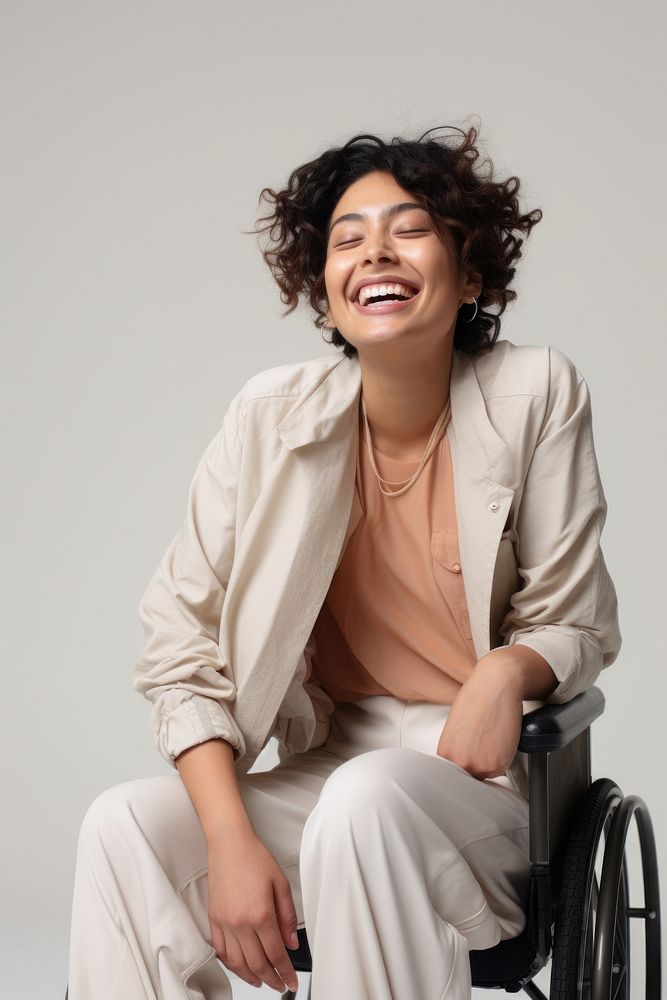 A disabled latinx woman wheelchair laughing smiling. AI generated Image by rawpixel.