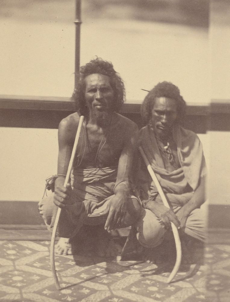 Portrait of Two Native Men Sitting on a Boat Holding Long Curved Sticks by Théodule Devéria