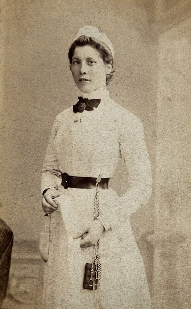 A nurse poses in uniform in a photographic studio. Photograph, 1860/1880.