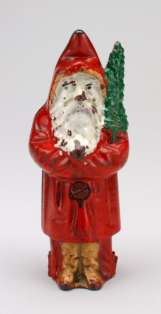 figure of man with white beard wearing red hooded coat trimmed with gold, gold boots and carrying a green branch; coin slot…
