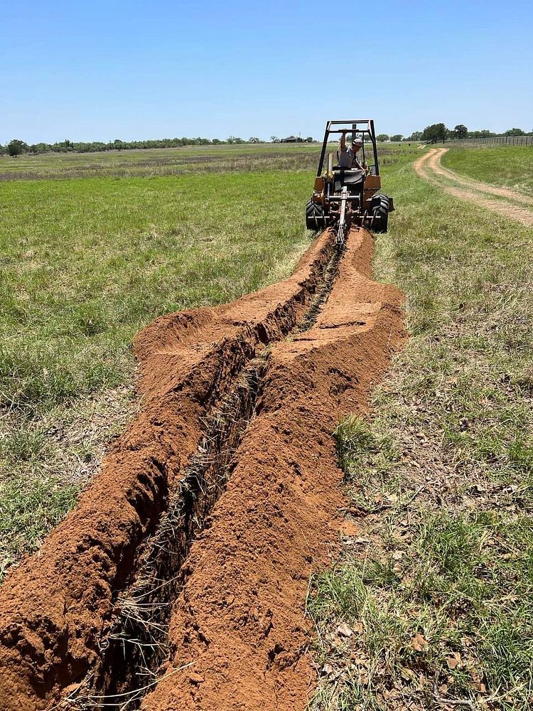 Traven Day and Stephen Thornhill begin livestock pipeline installation at the C.G. Merlo Ranch in San Saba, Texas, on June…