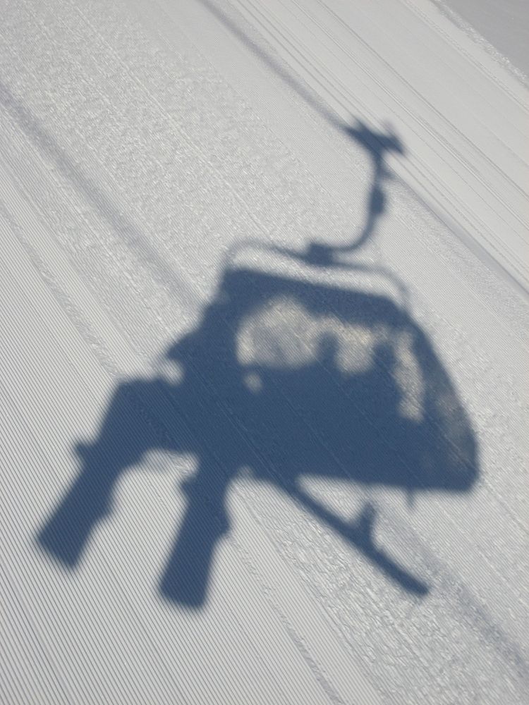 Shadow of a chairlift. Free public domain CC0 image.