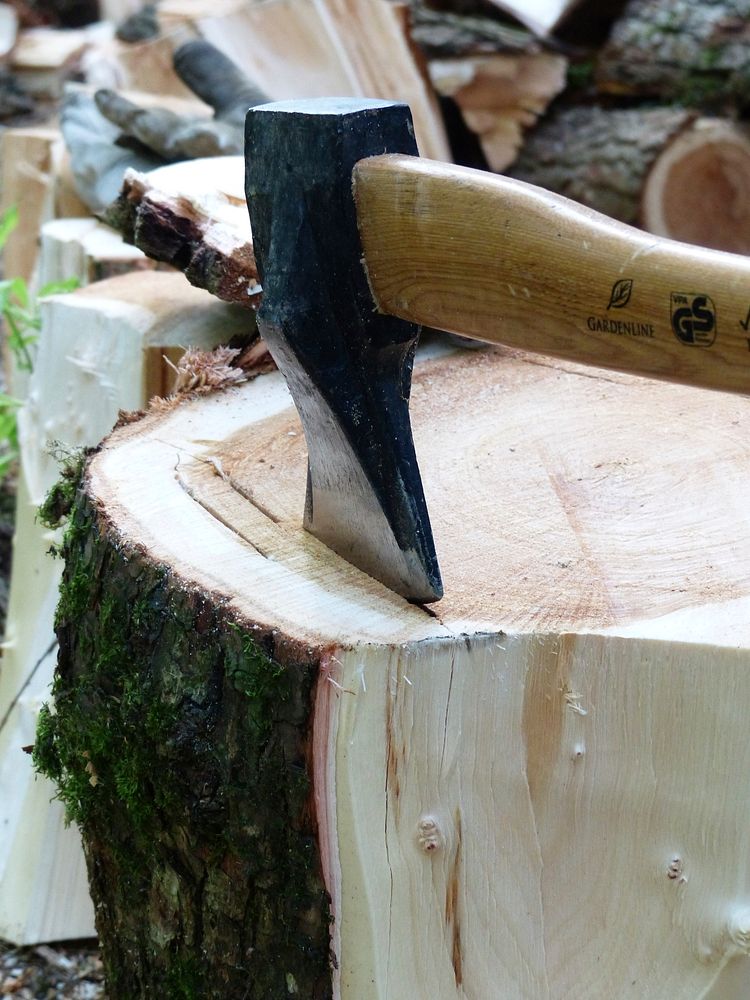 Axe cutting wood. Free public domain CC0 photo.