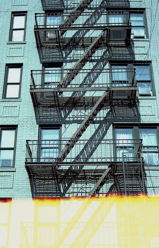 Exterior view of building with fire escape stairs in New York City, free public domain CC0 image.