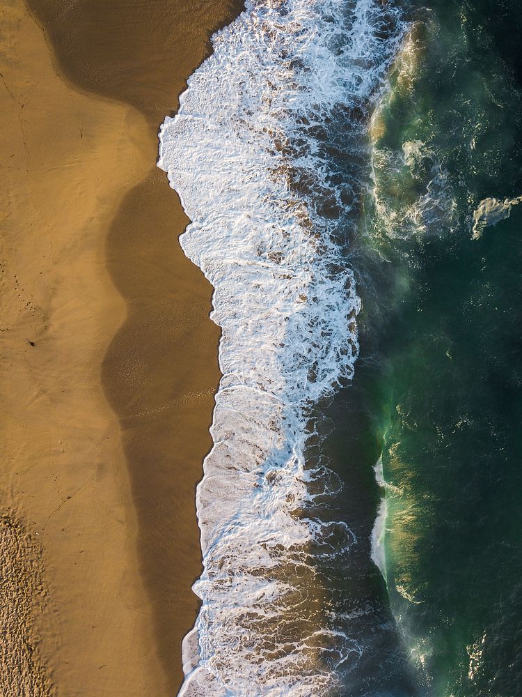 Aerial view of blue ocean waves with sandy beach, free public domain CC0 photo.