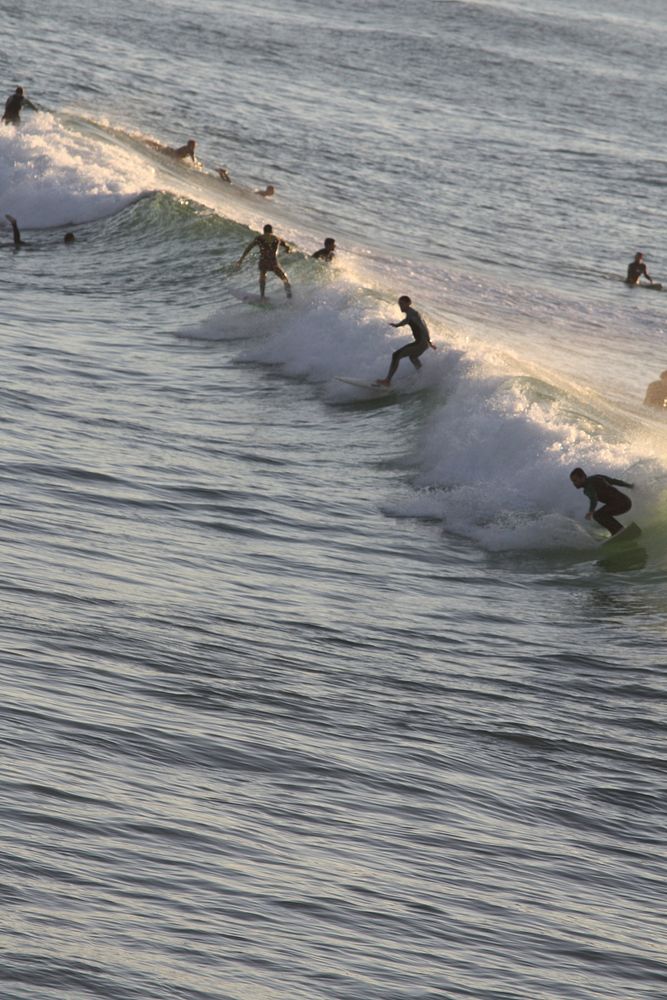Surfers catching waves, sports photography. Free public domain CC0 image.