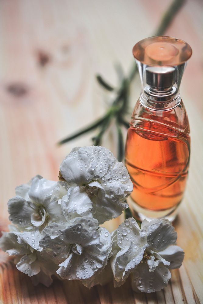 White flower and perfume bottle. Free public domain CC0 image.