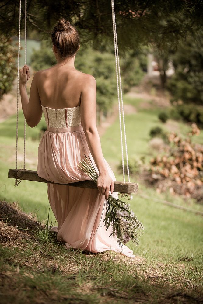 Free bride sitting on a swing image, public domain wedding CC0 photo.