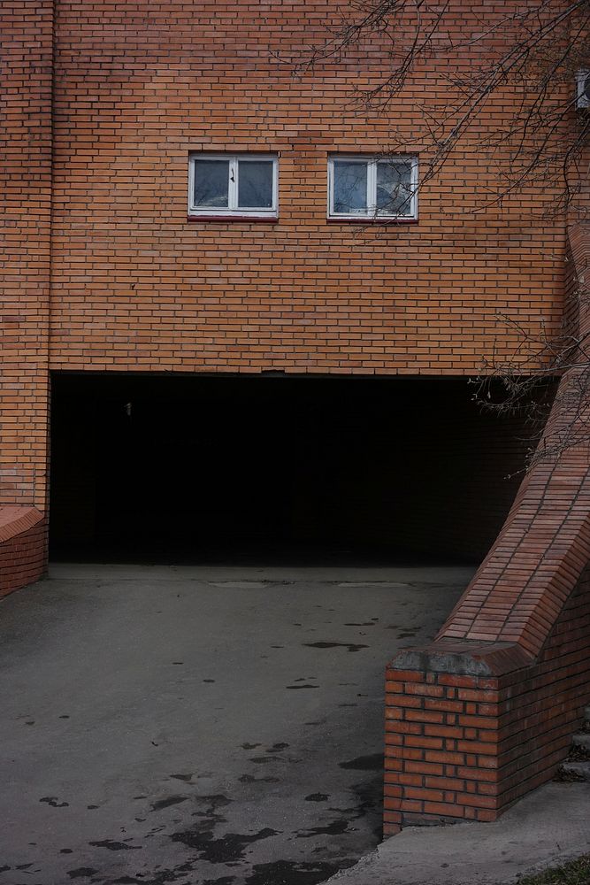 Free brick wall parking entrance image, public domain architecture CC0 photo.