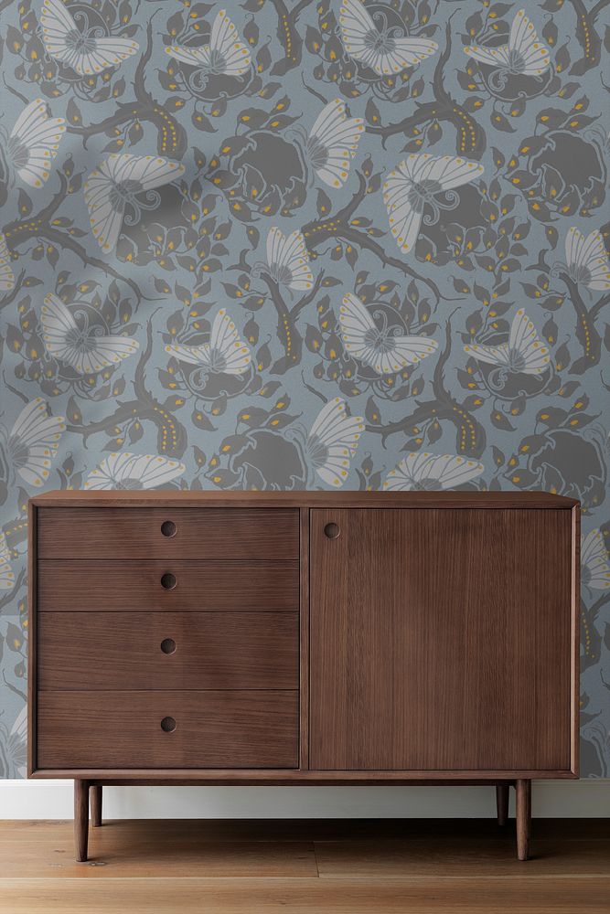 Mid century modern wood cabinet by a blue wall with Art Nouveau wallpaper 