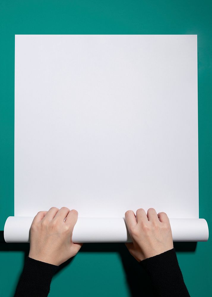 Blank white paper, held by hand, design space