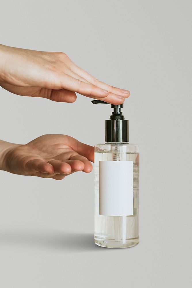 Hand pumping sanitizer gel out of bottle