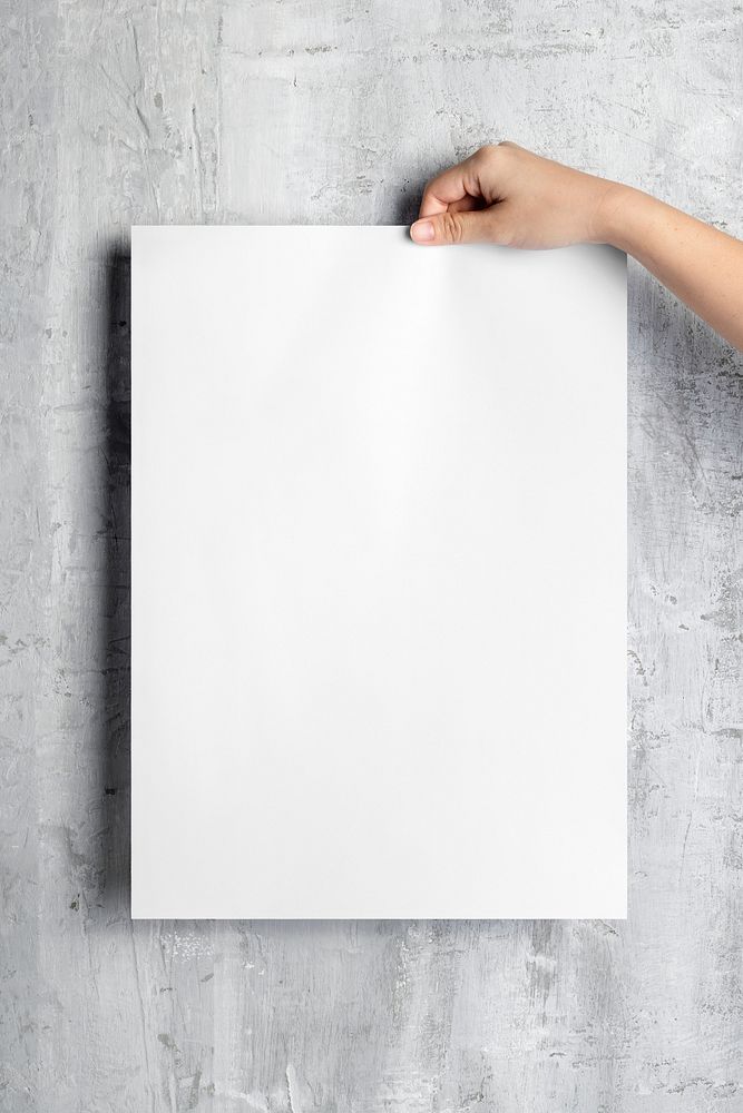 Woman holding blank white poster on grunge wall