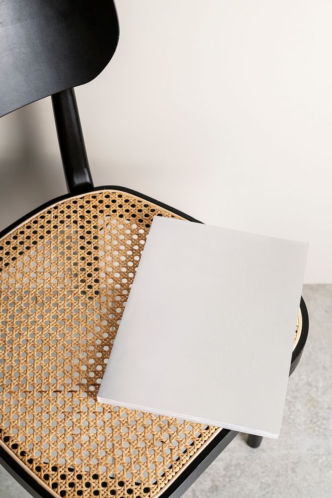 White magazine with blank cover on rattan chair
