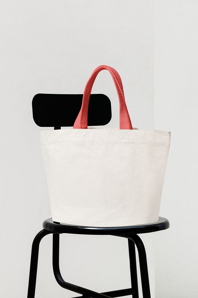 White canvas tote bag on black chair