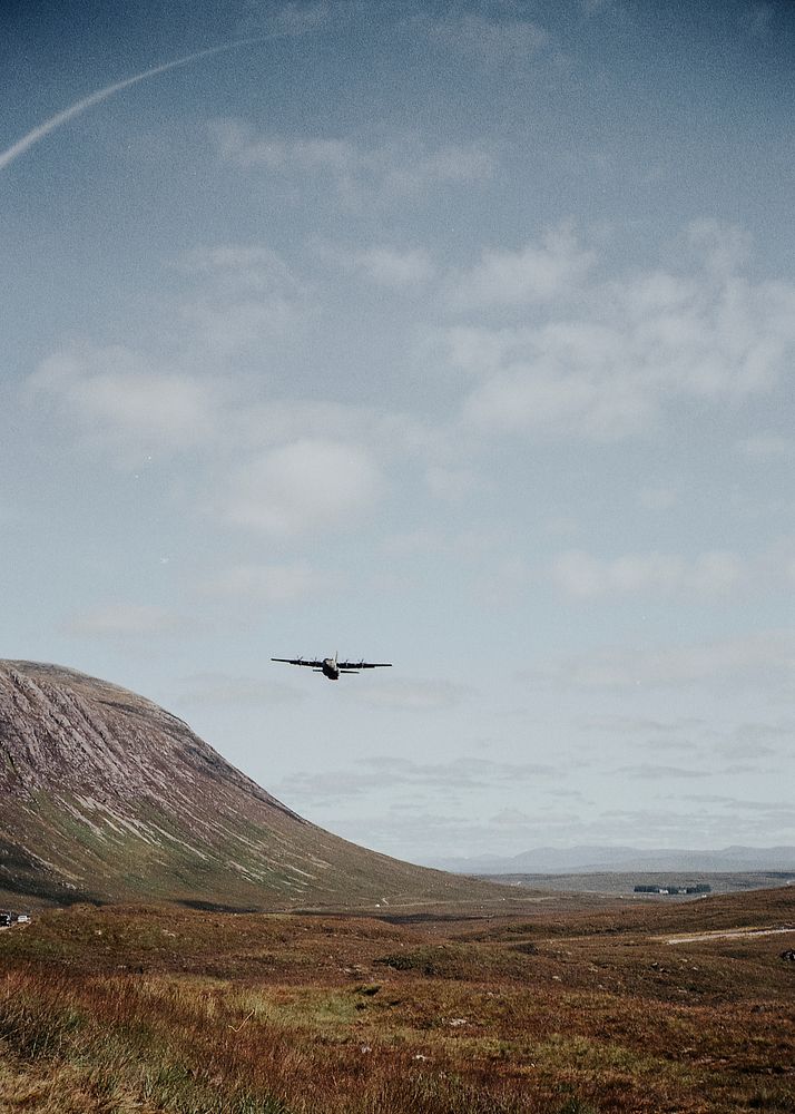 Old military plane over Glencoe Valley, Scotland