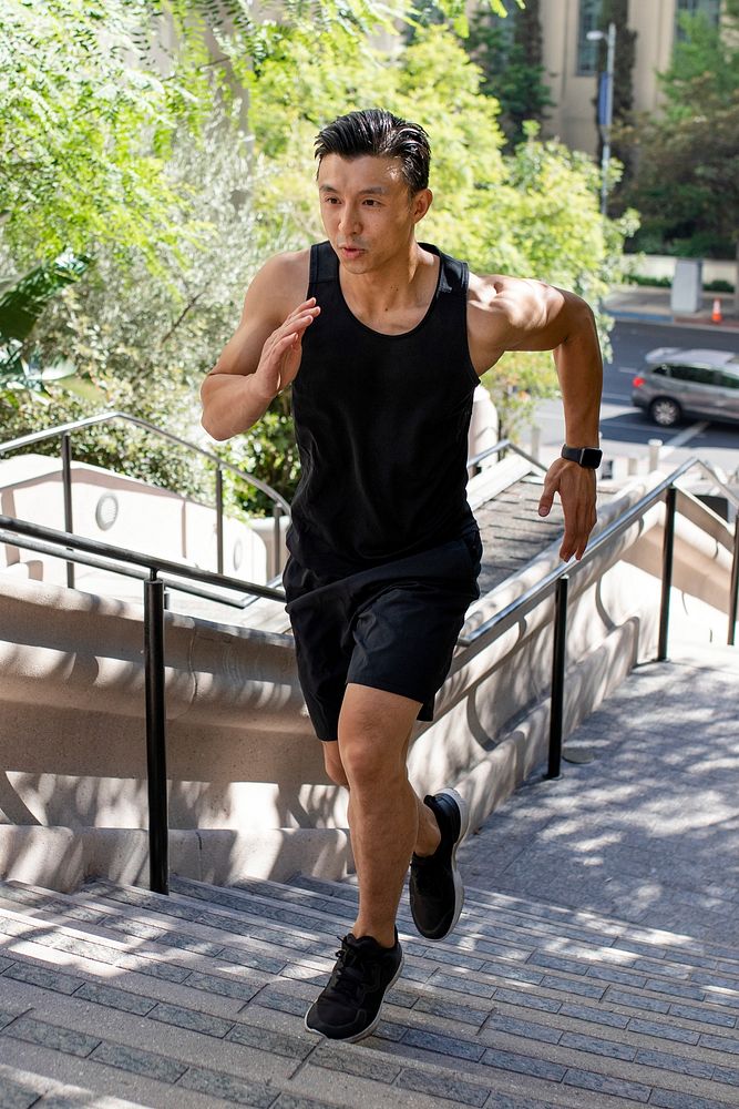 Asian man running up the steep stairs 