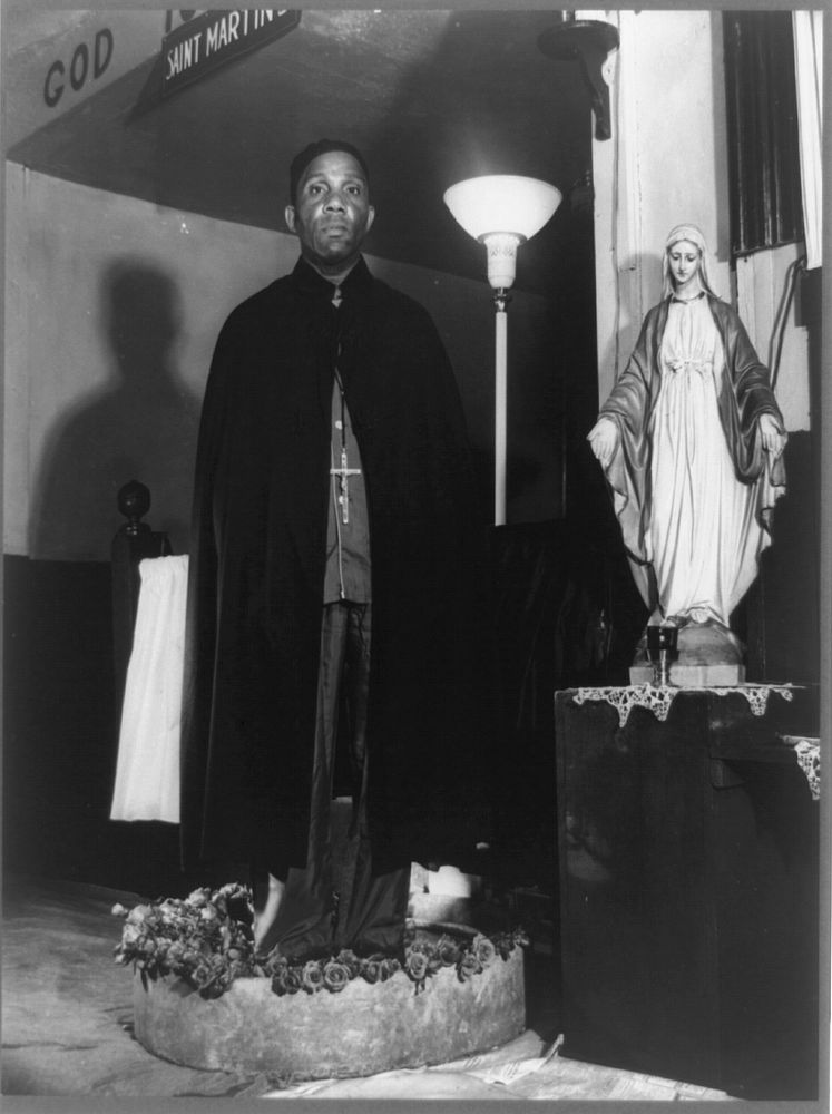 Washington, D.C. Reverend Vondell Gassaway, pastor of the St. Martin's Spiritual Church standing in a bowl of sacred water…