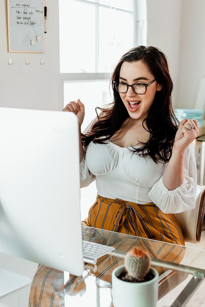 Happy woman working on her computer