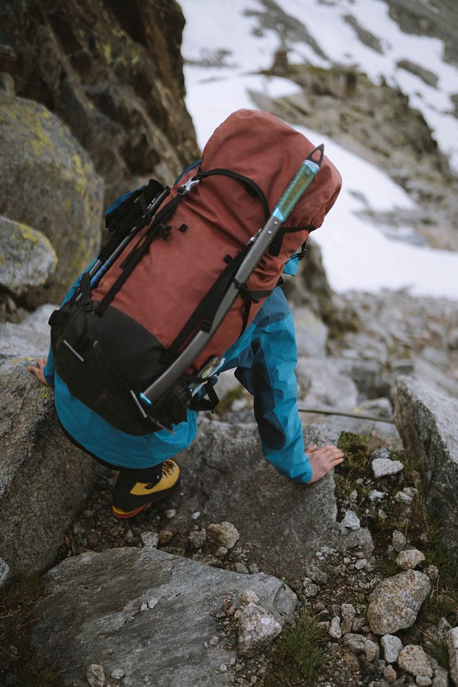 Backpacker hiking down the Chamonix Alps in France