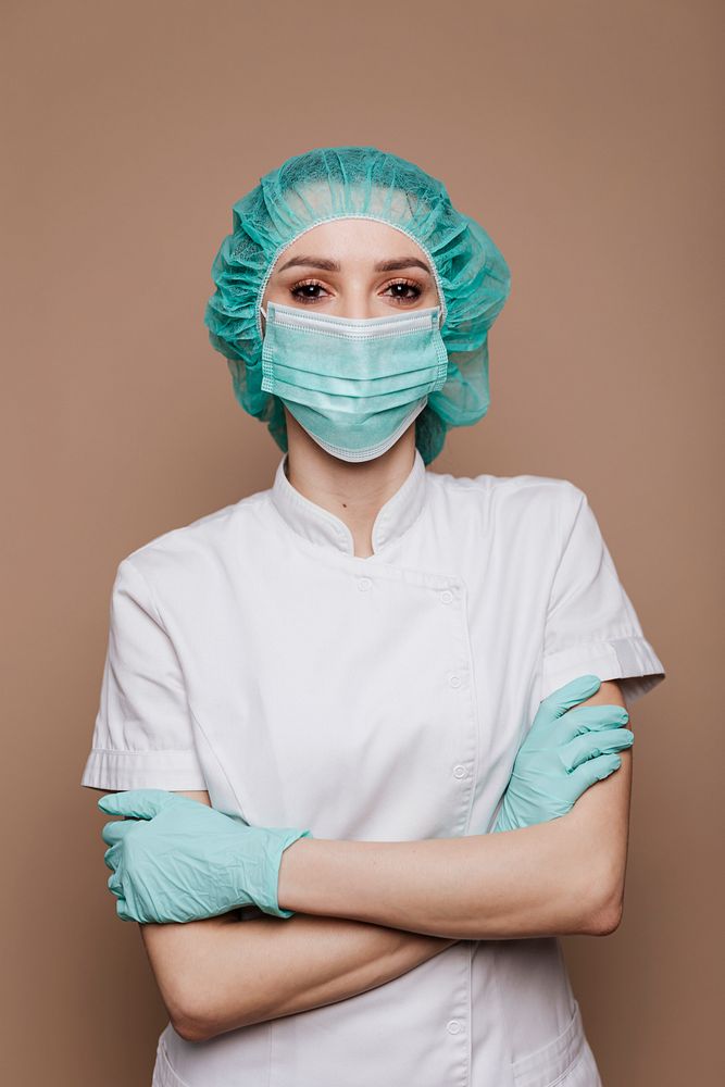 Confident microbiologist wearing gloves mask and surgical cap