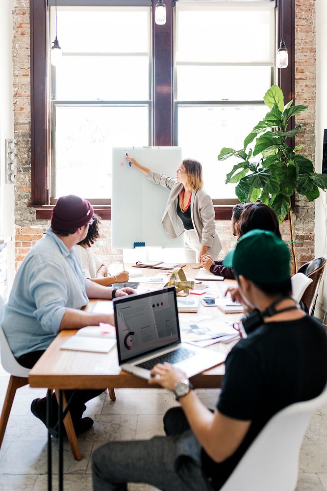 Businesswoman writing on a board in the meeting room