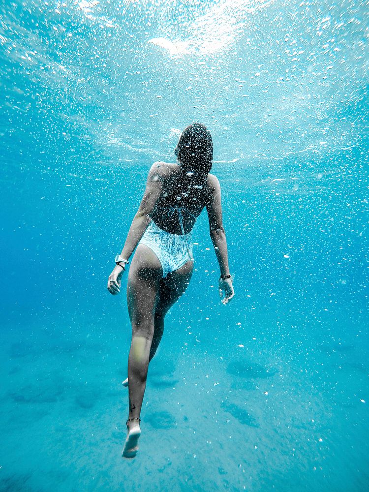 Woman swimming under water. Original public domain image from Wikimedia Commons