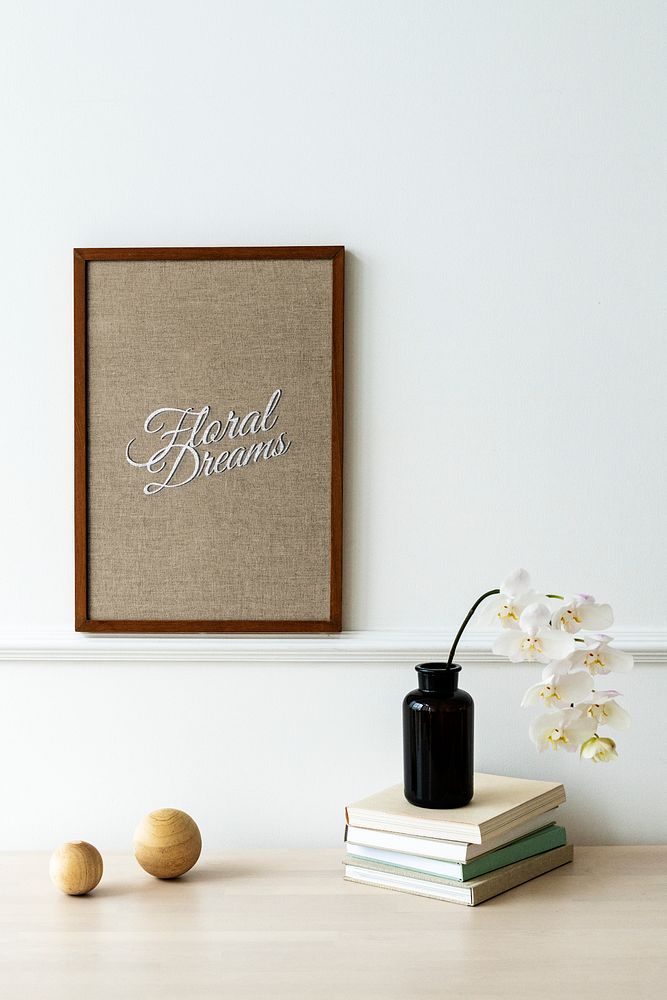 Wooden photo frame mockup hanging on a white wall